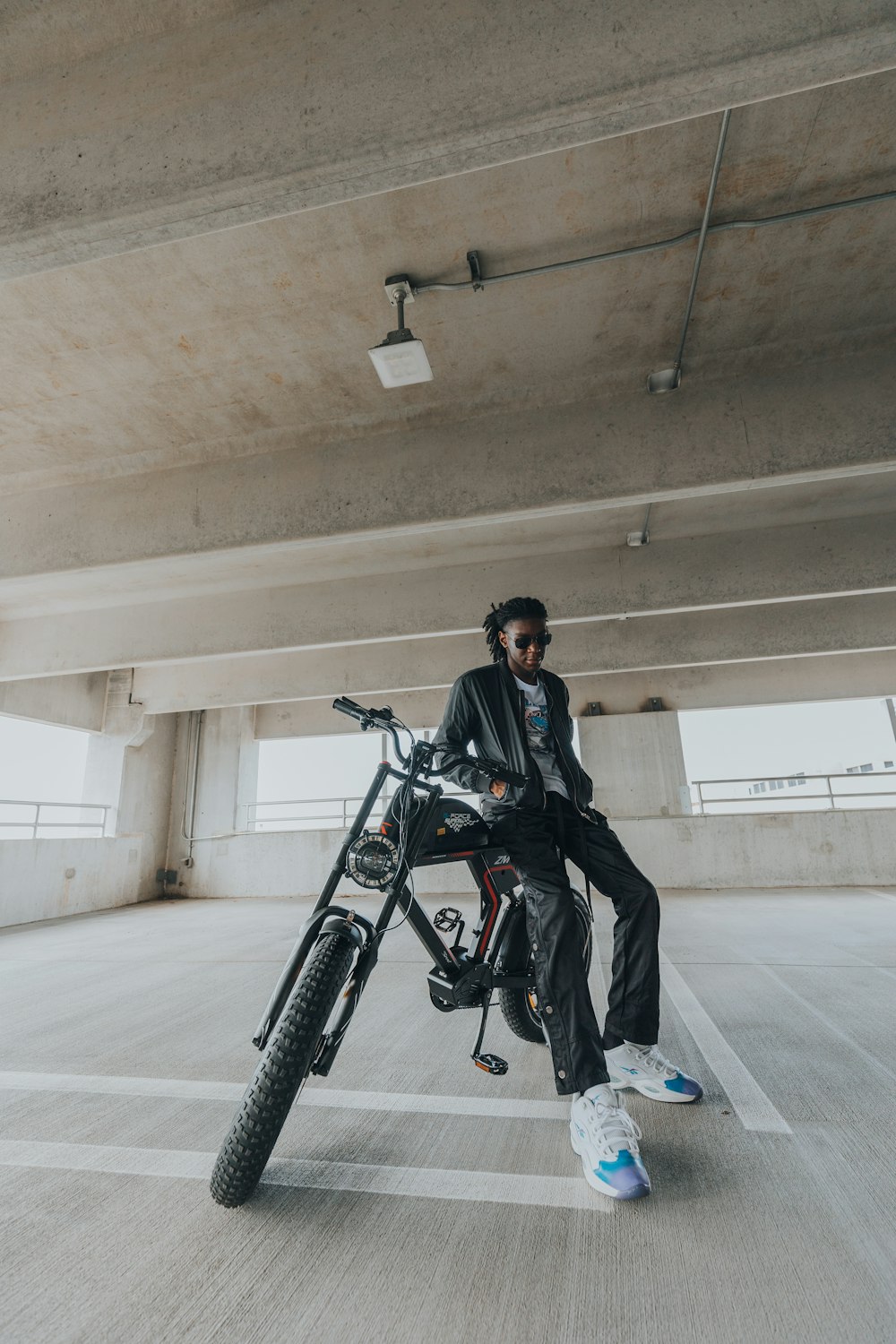 a man standing next to a bicycle