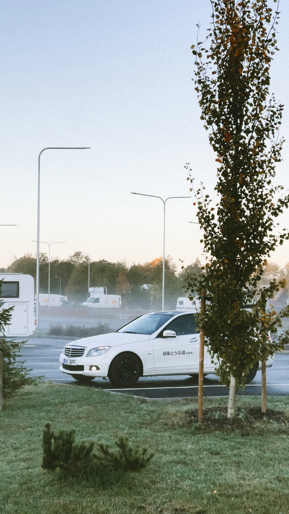 a white car parked on the side of a road