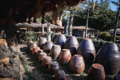 An outdoor scene featuring clay pots arranged in a garden.