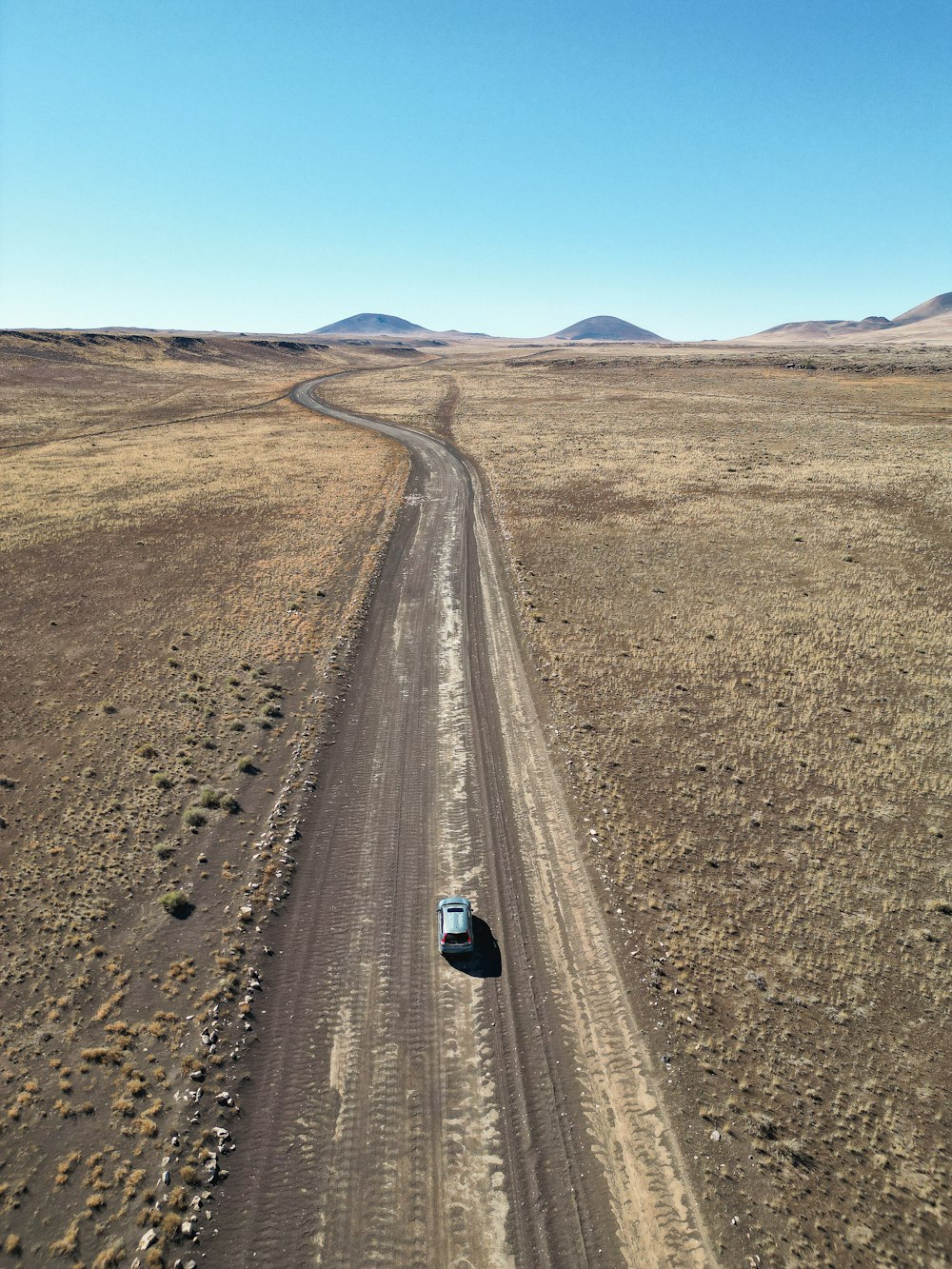 a car driving on a dirt road