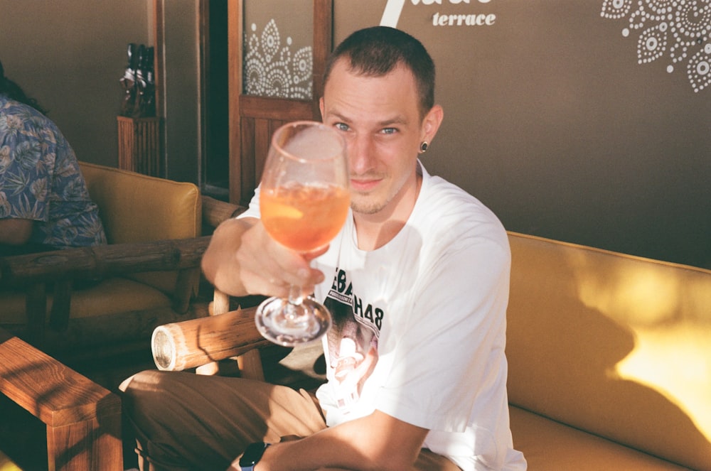 a man holding a glass of wine