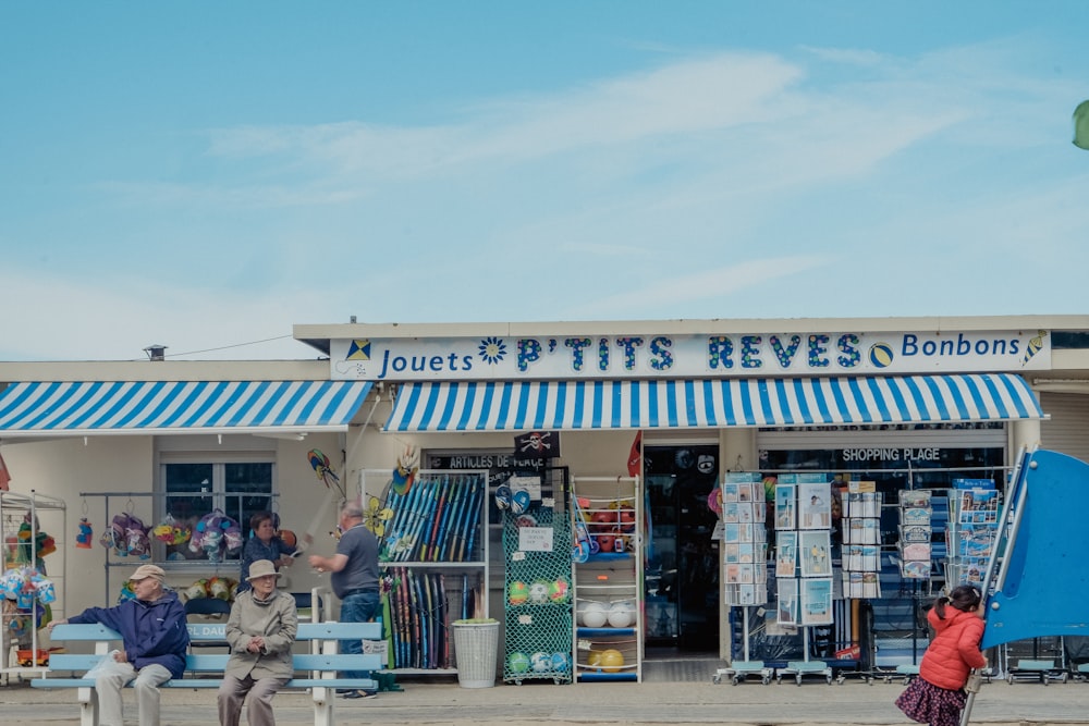 people sitting outside a store