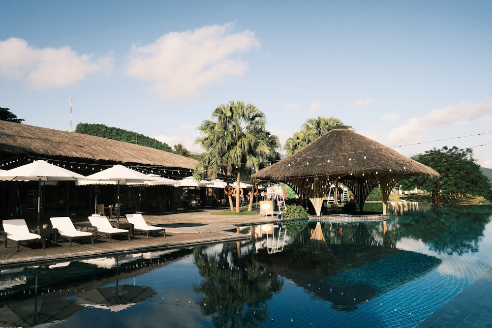 a pool with umbrellas and chairs by it