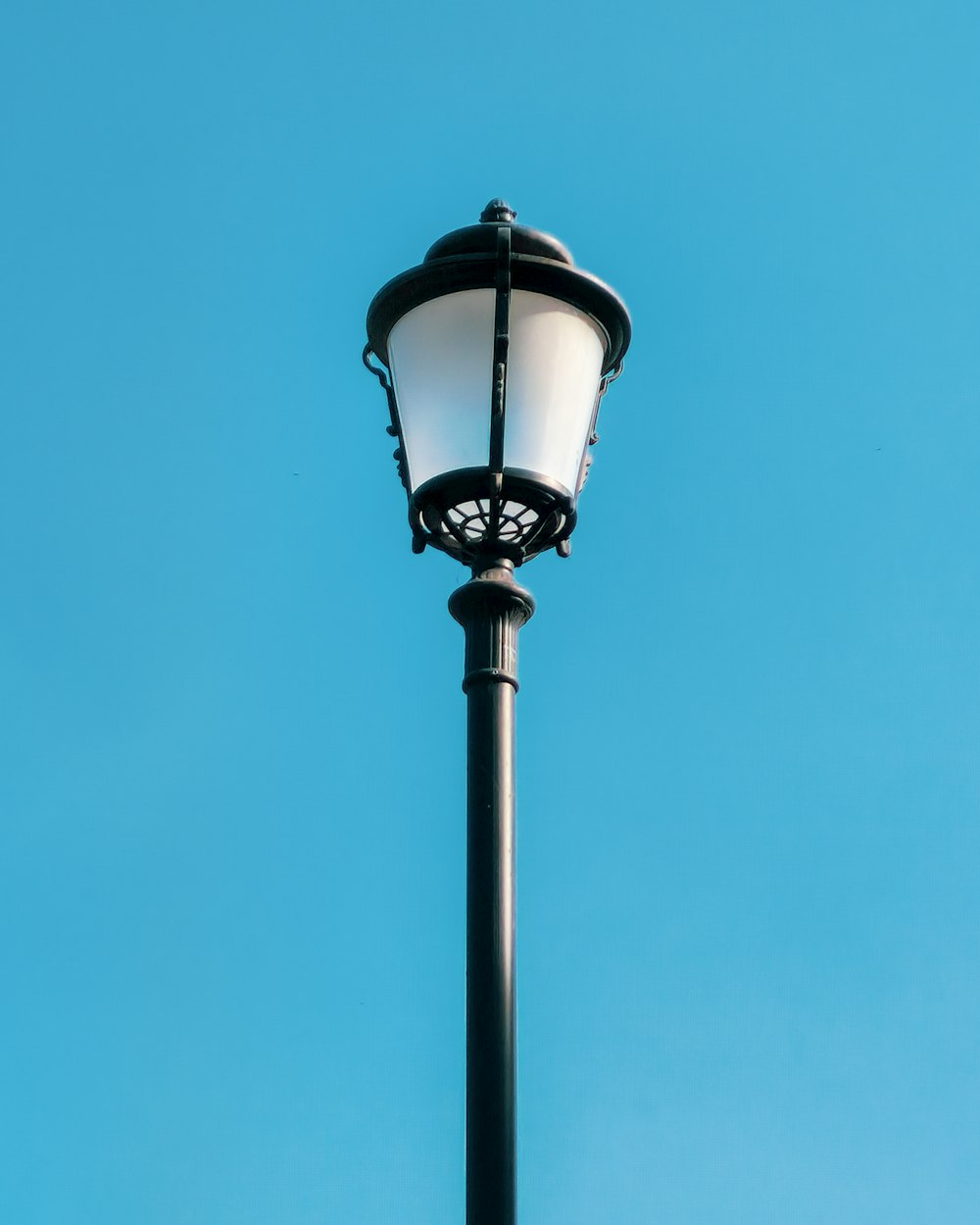 a light post with a blue sky