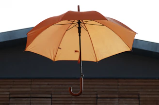 an orange umbrella on a roof