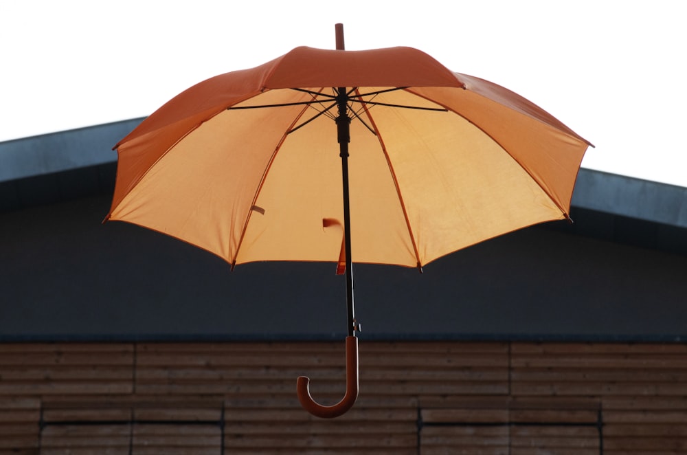 an orange umbrella on a roof