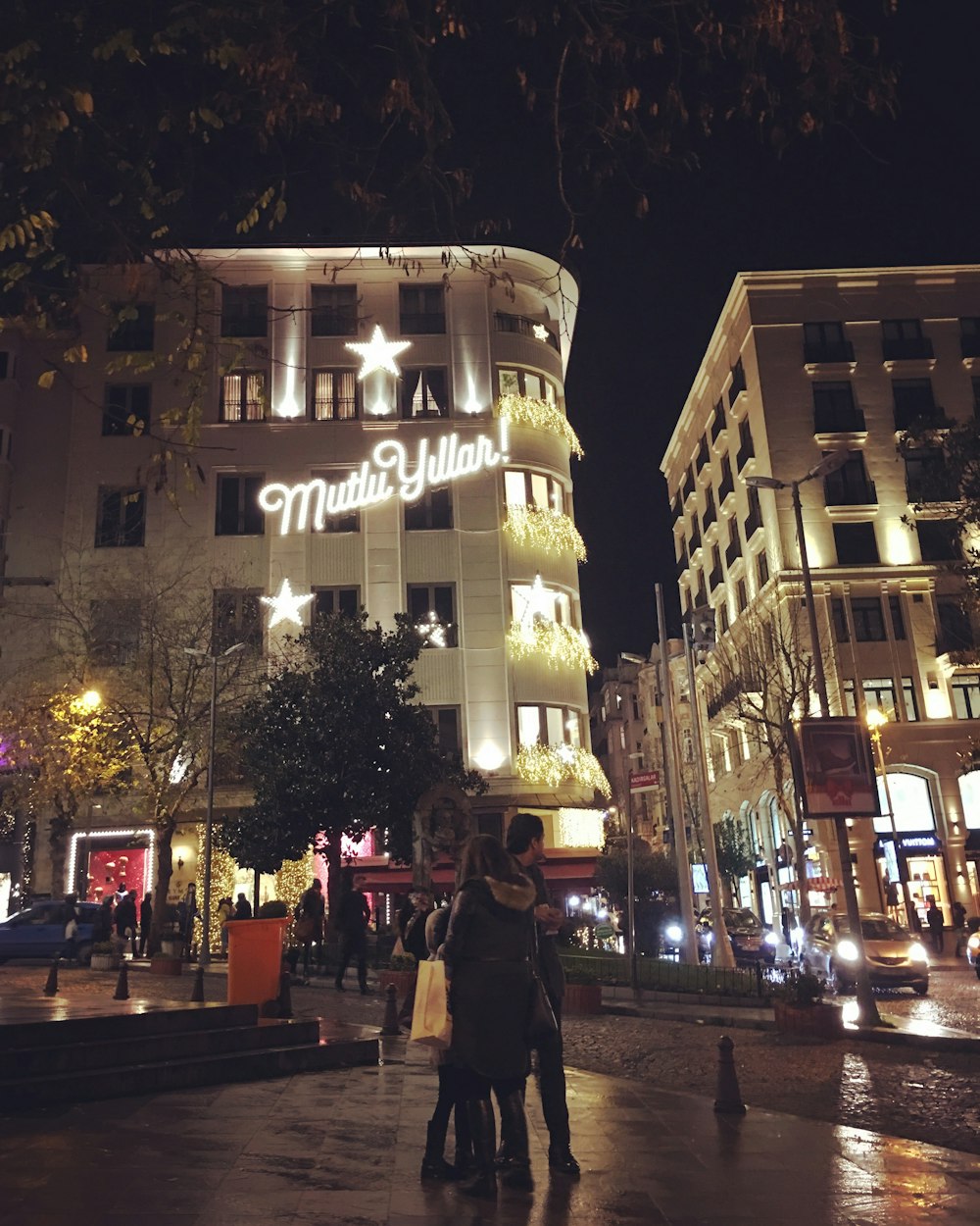 a person walking on a sidewalk in front of a building