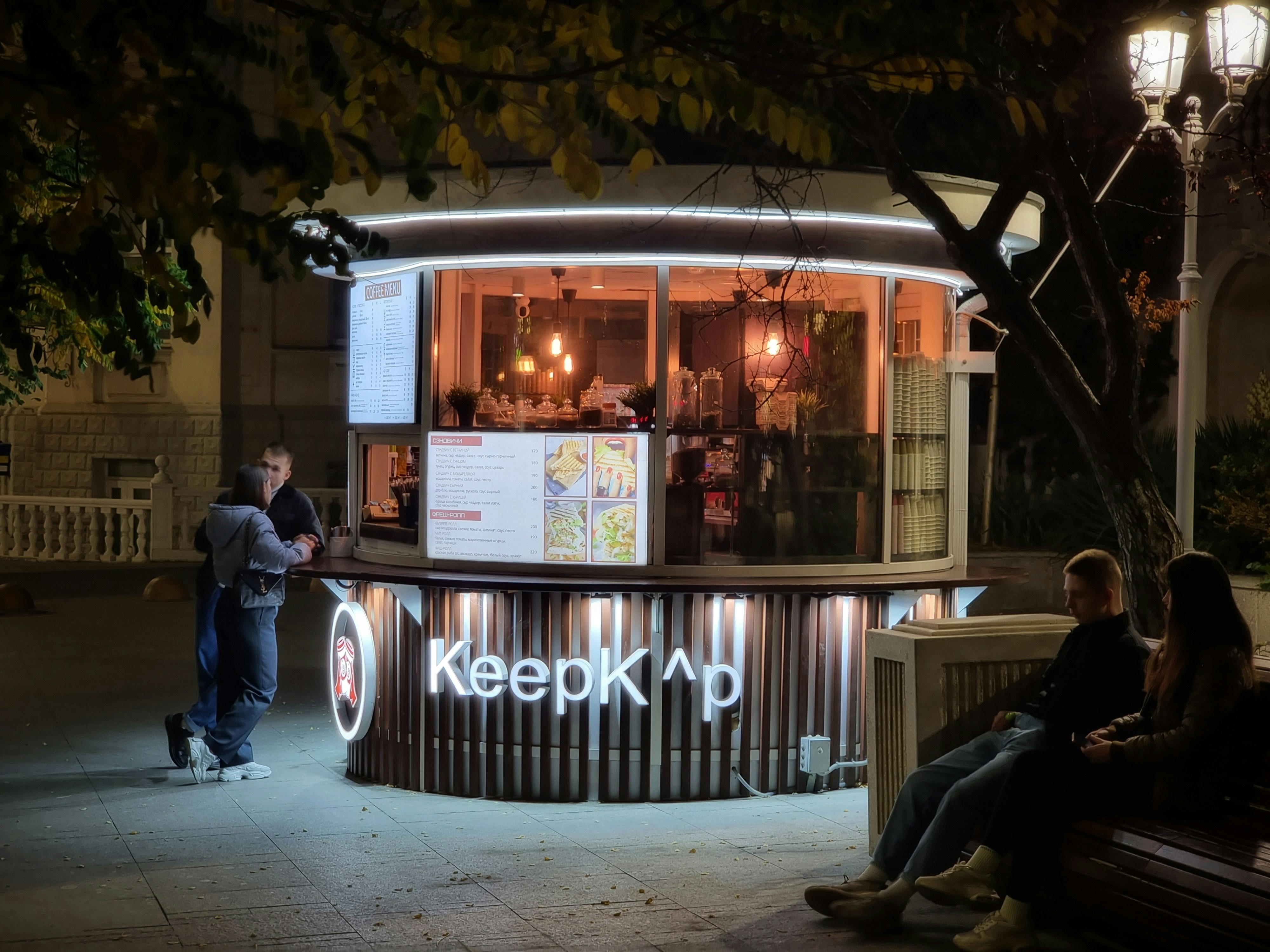 a person standing outside a restaurant