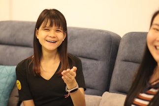 A friendly loan officer speaking with a family in a cozy home setting.