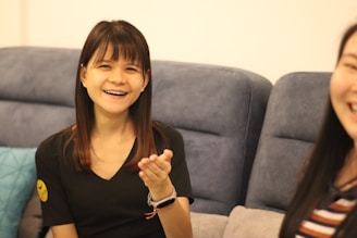 A friendly property manager discussing lease details with a smiling tenant in a cozy living room.