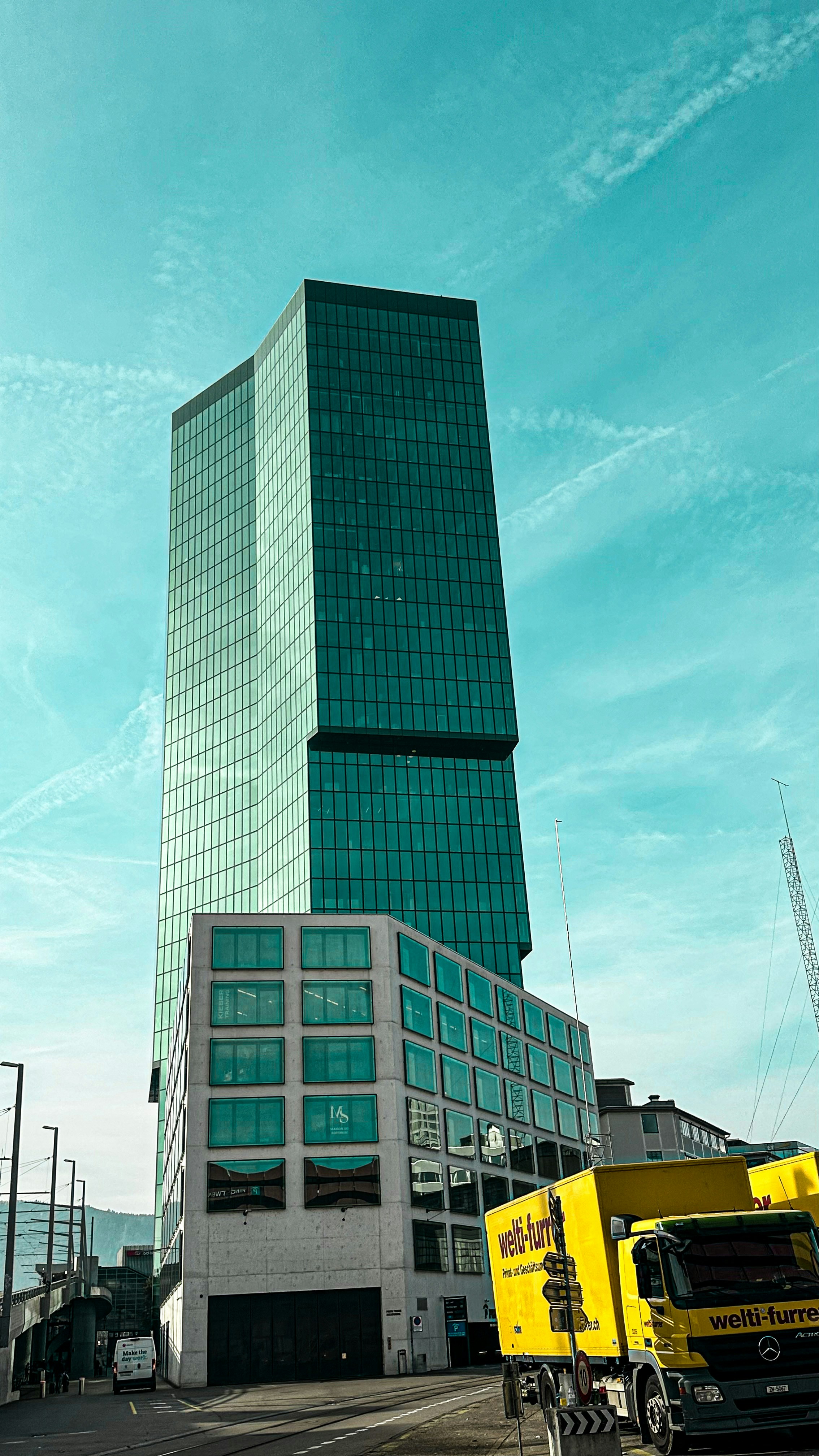 a tall building with a truck in front of it