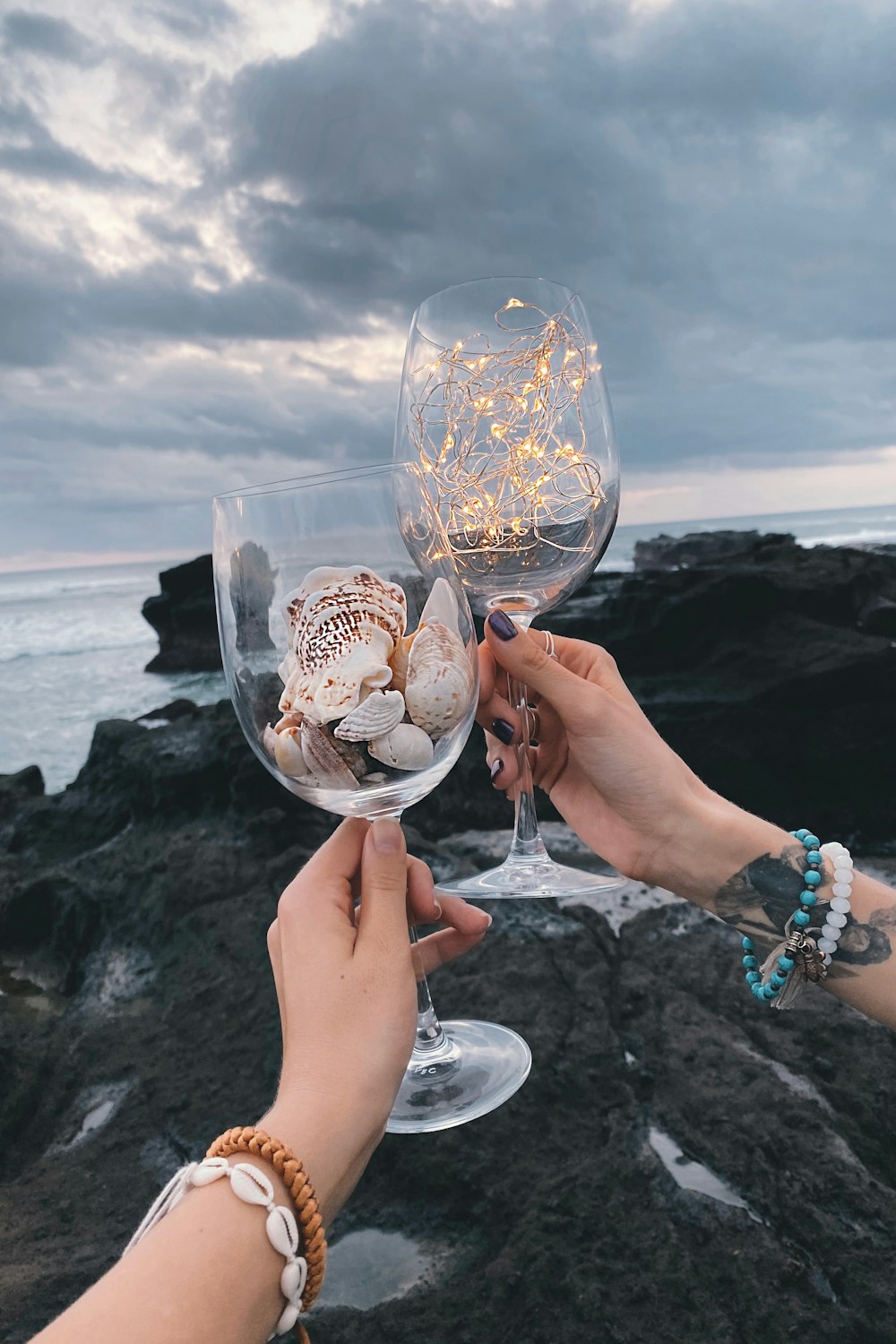 a couple of hands holding a glass of ice cream