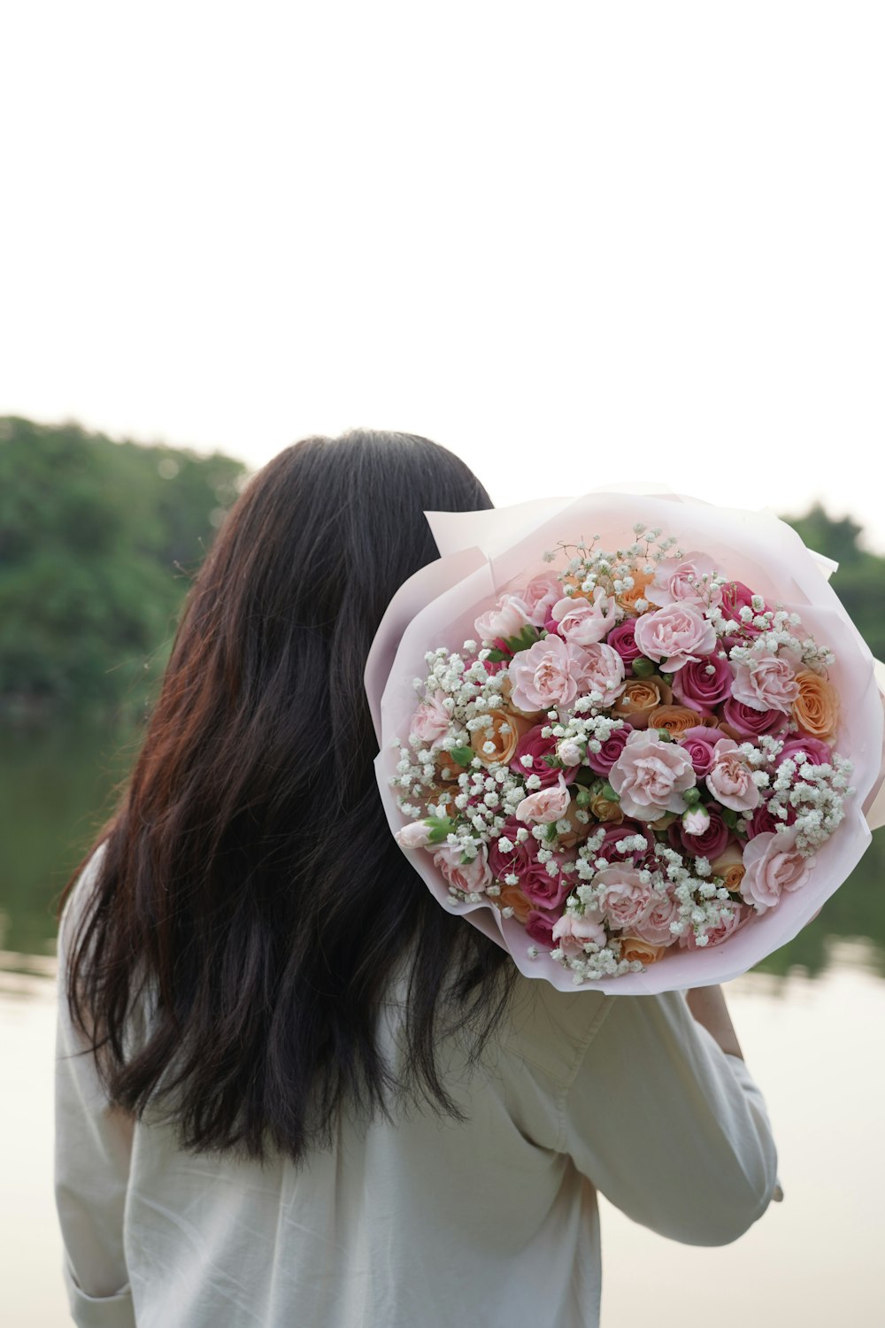 a woman holding a bouquet of flowers