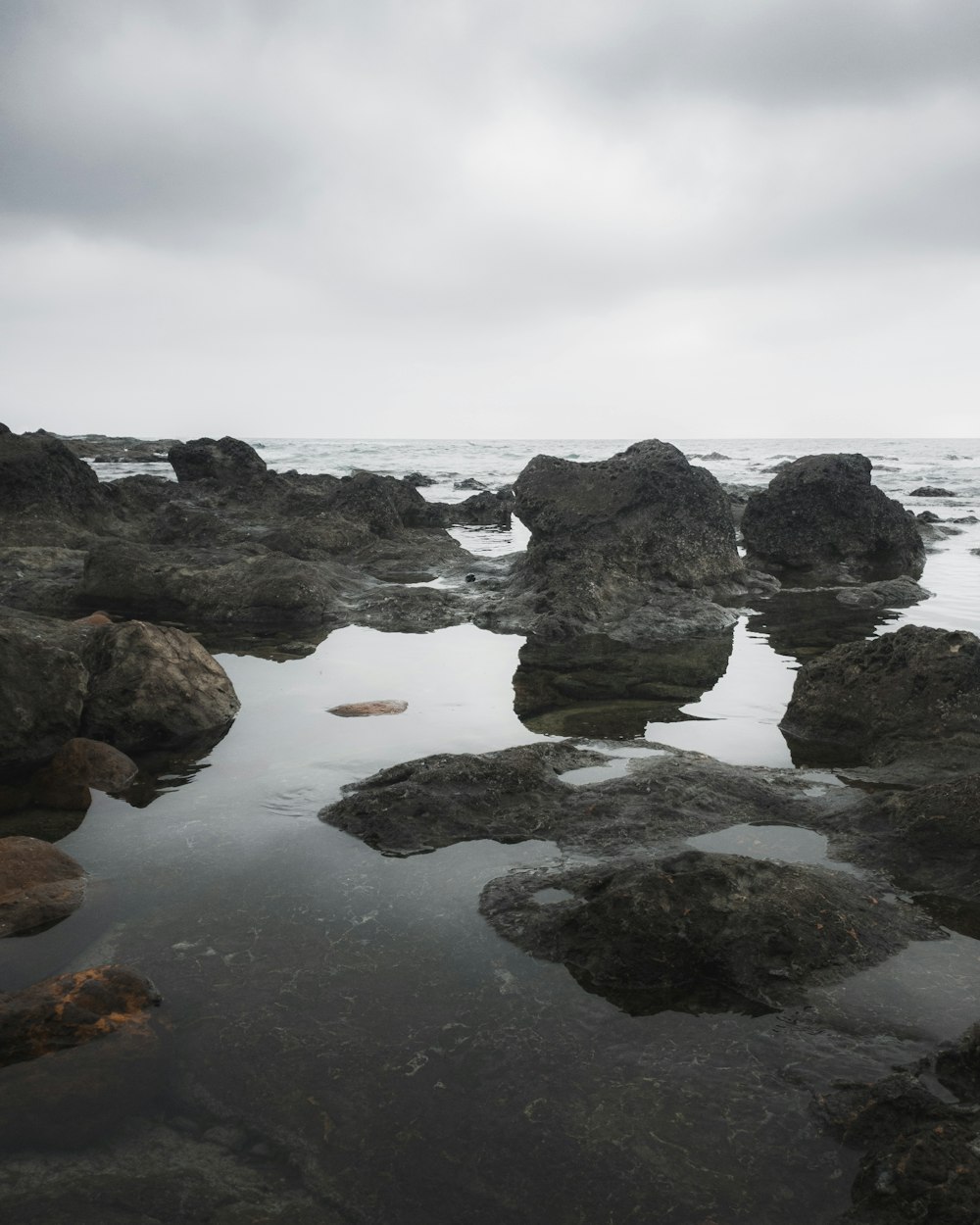 a rocky beach with waves crashing