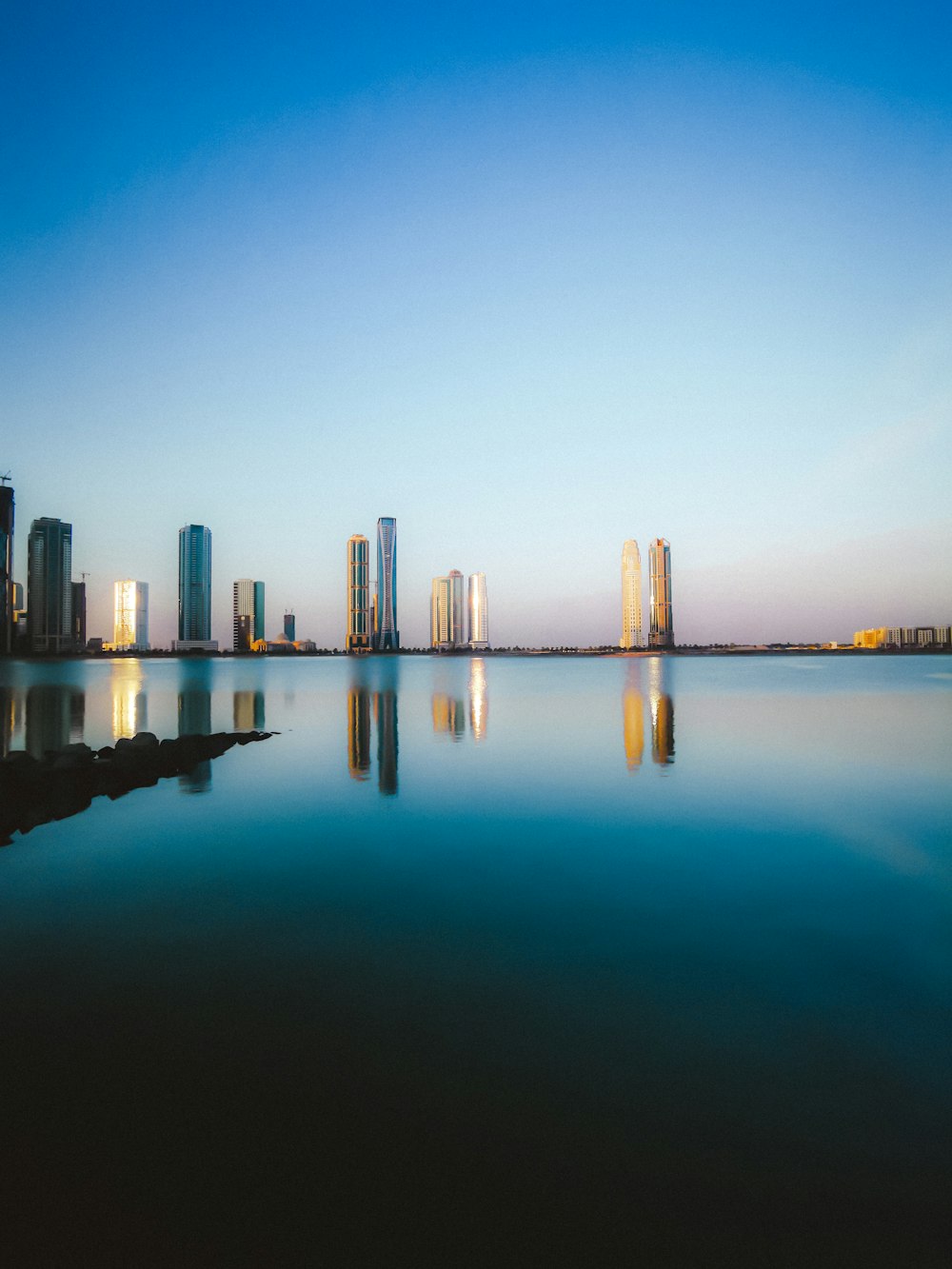 a city skyline reflected in water