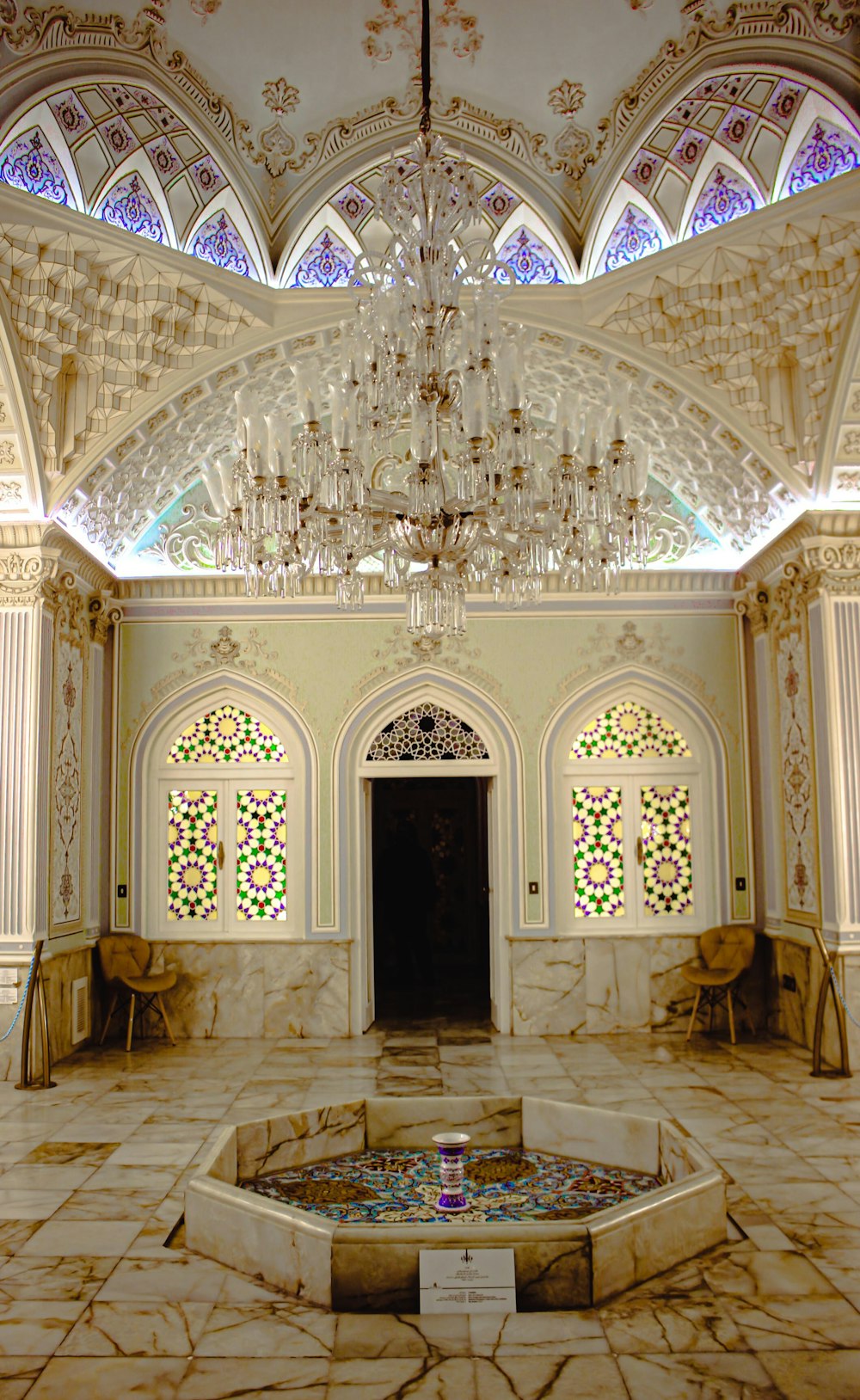 a large ornate room with a chandelier and a round table