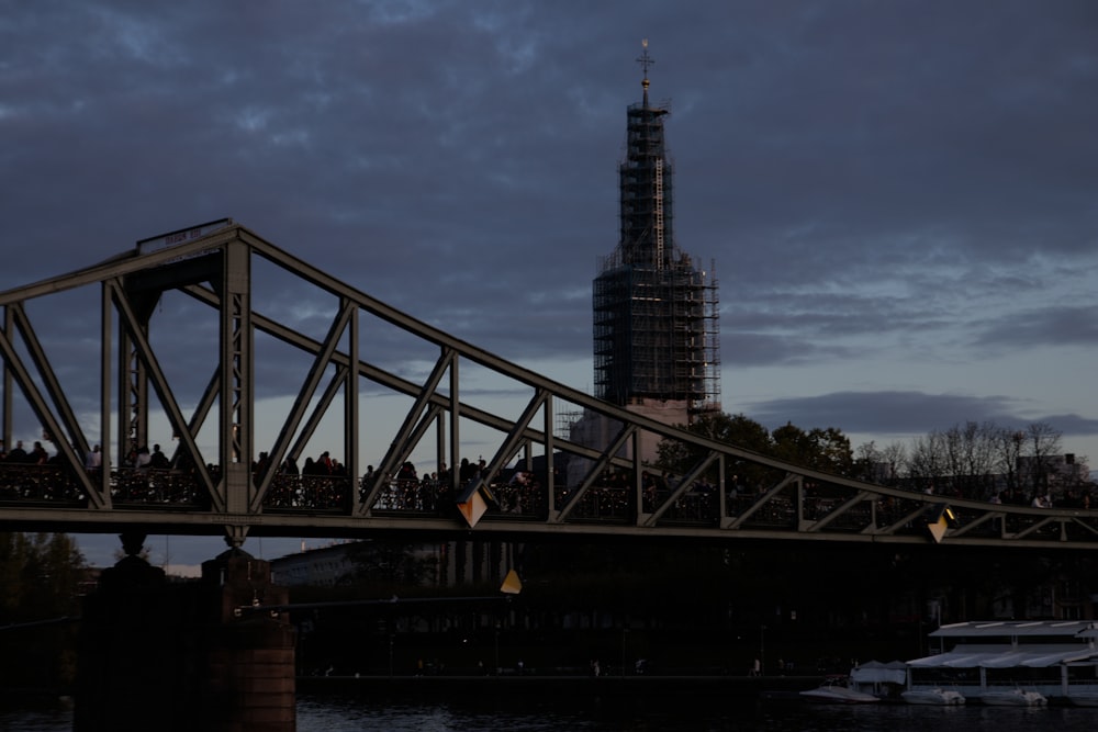 a bridge with a tower in the background