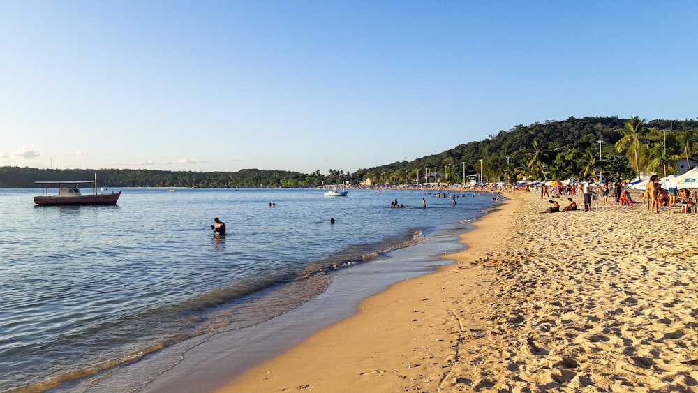 a beach with people and boats