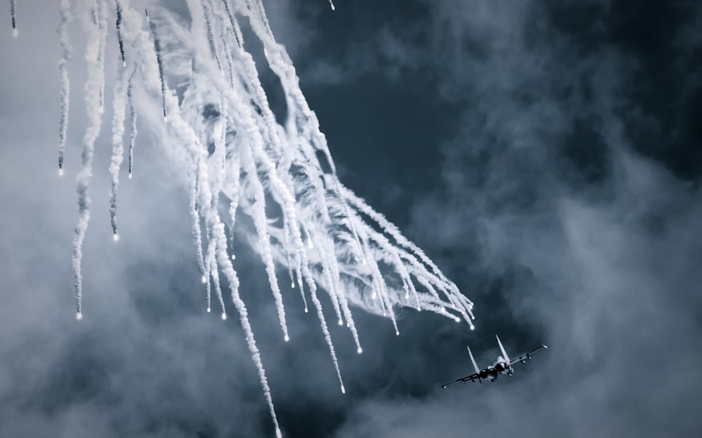 a group of planes flying in the sky with smoke coming out of them