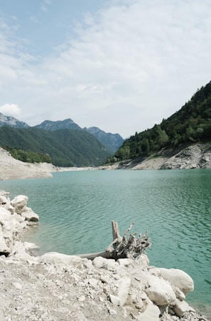 a body of water with mountains in the background