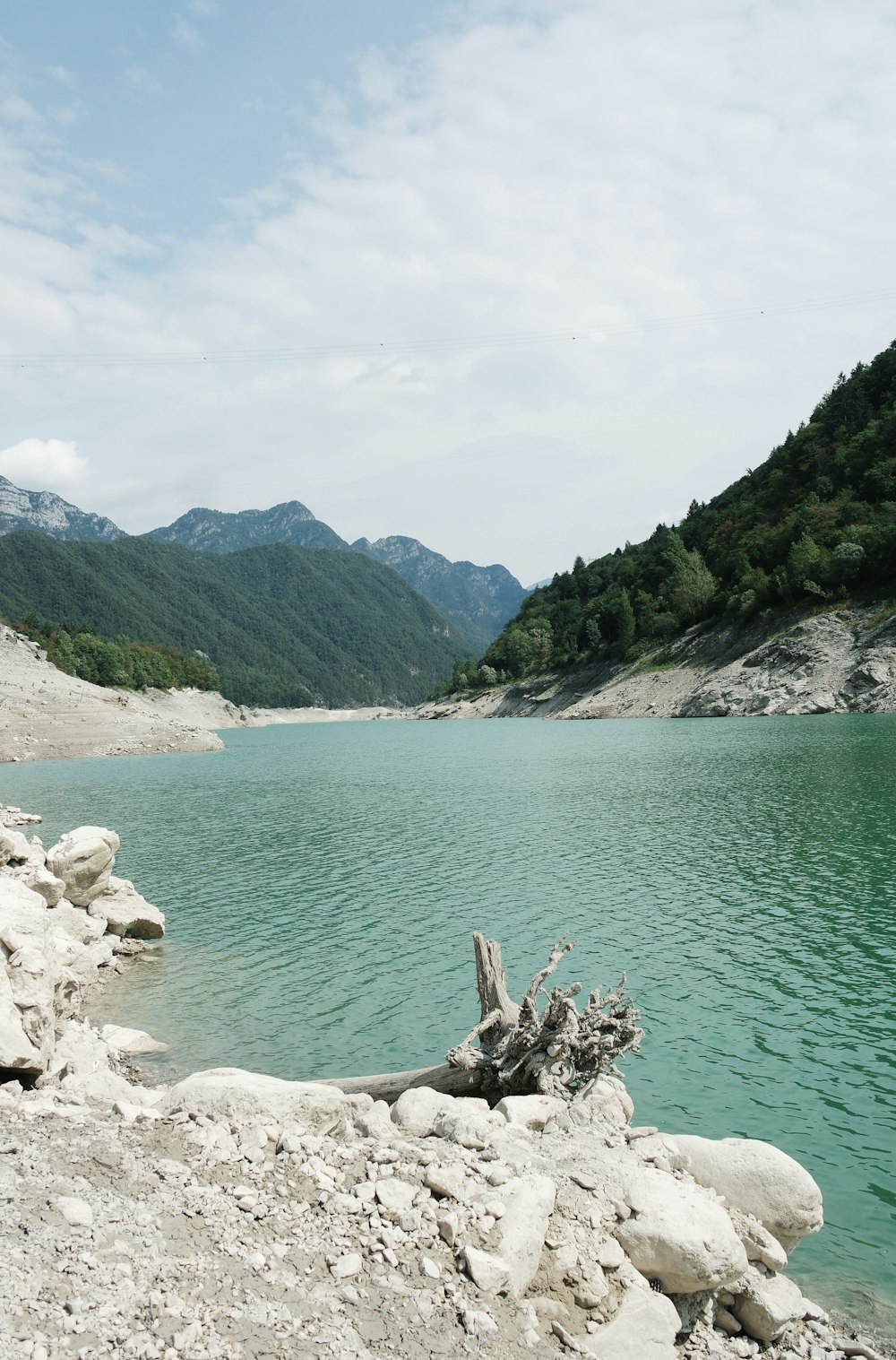 a body of water with mountains in the background