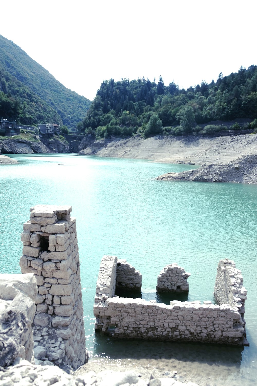 a body of water with rocks and trees around it