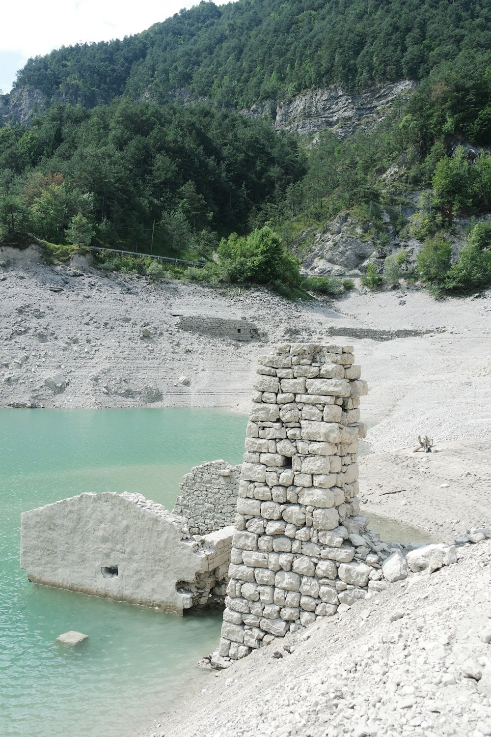 a stone wall on a beach