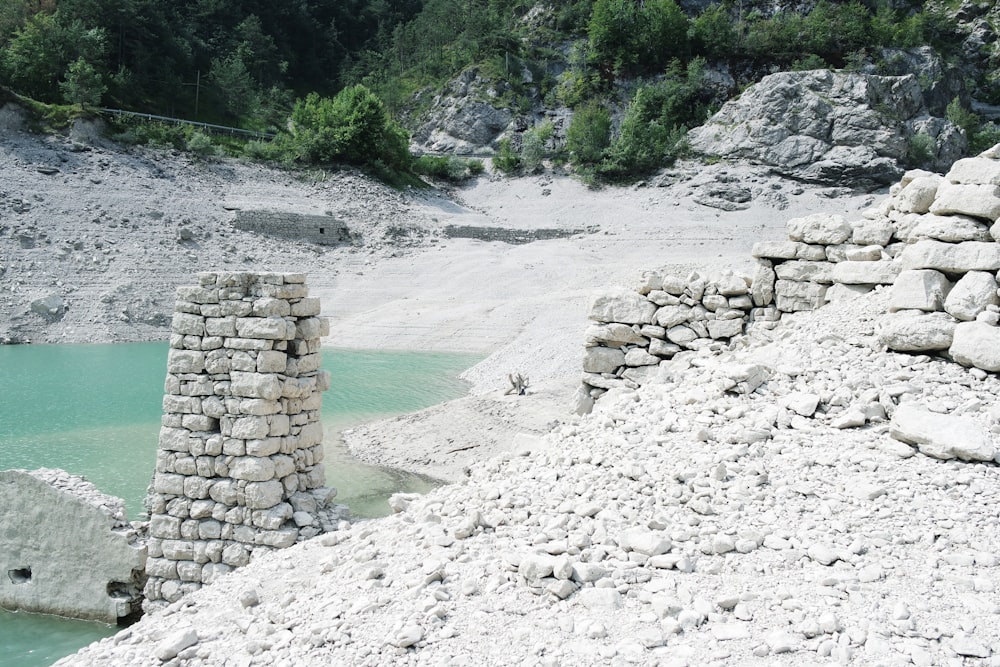 a rocky beach with a pool