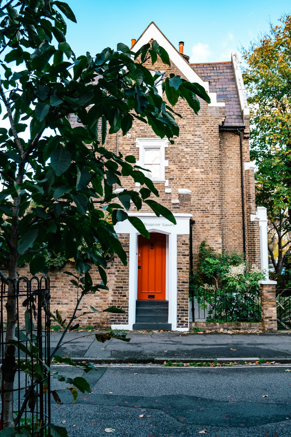 a brick house with a gate with Thomas Edison House in the background