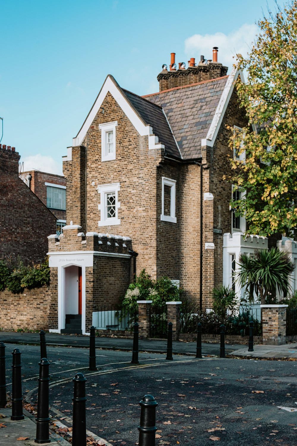 a brick building with a fence in front of it