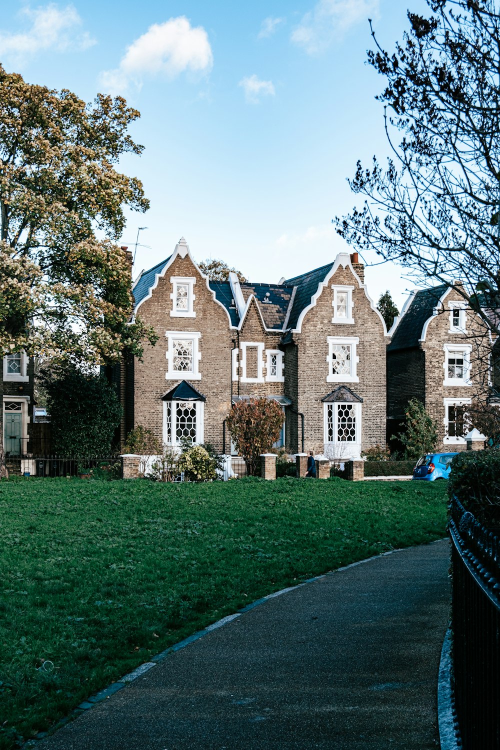 a large brick building with a lawn in front of it