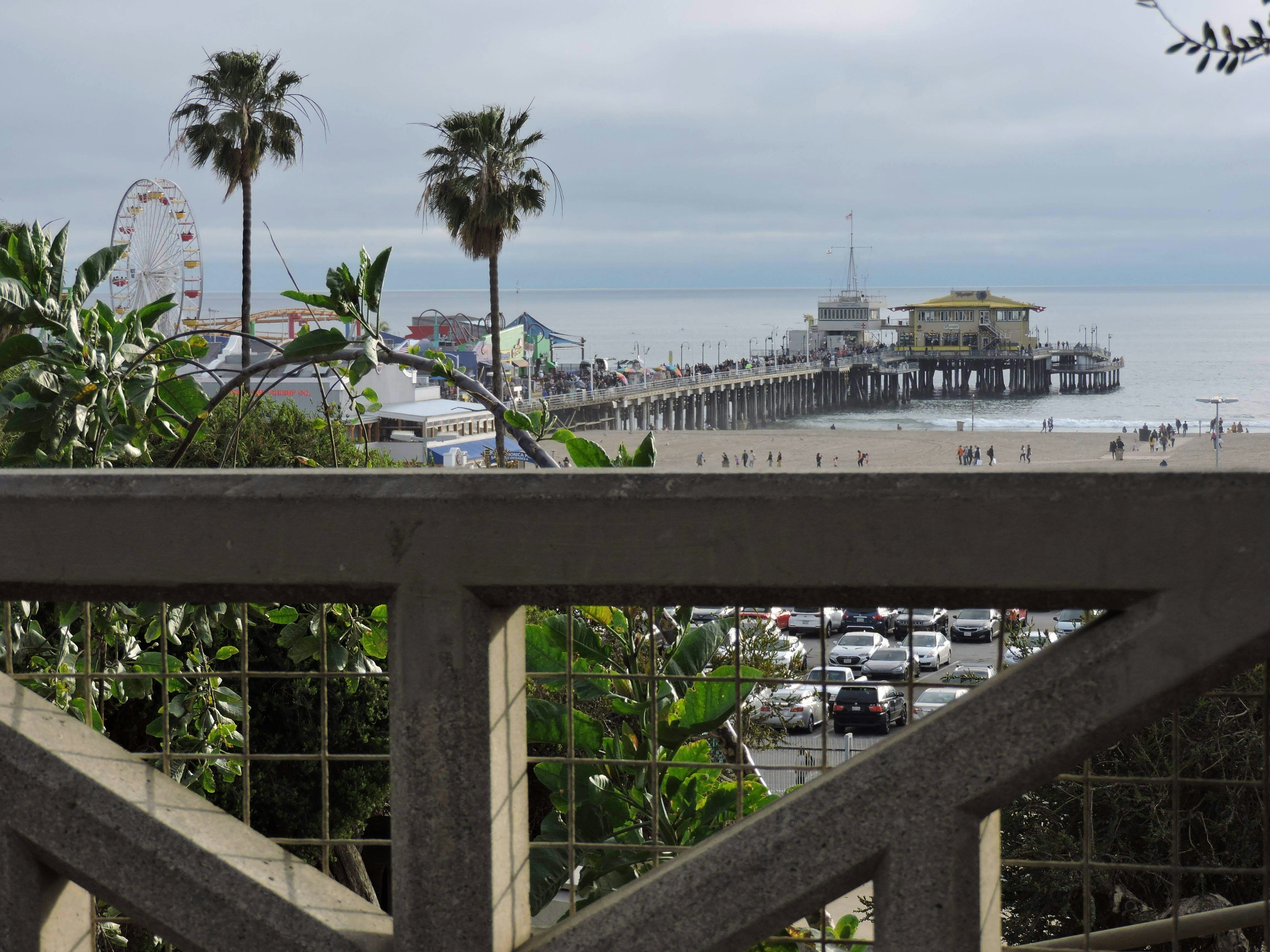 a road with cars and a body of water in the background