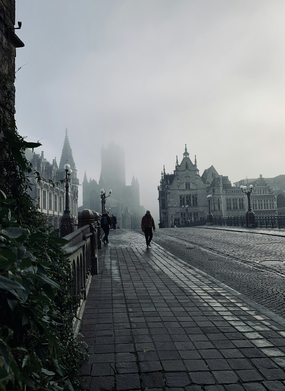 a person walking on a stone path in front of a large building