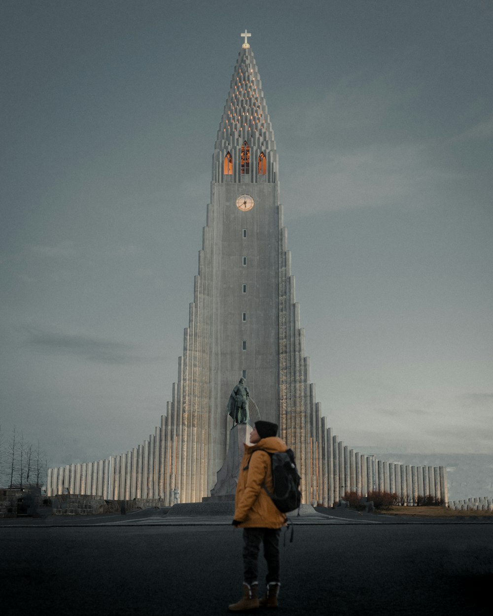 a person standing in front of a tall building with Hallgrímskirkja in the background