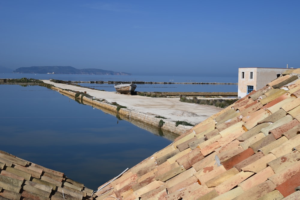 a brick wall with a body of water in the background