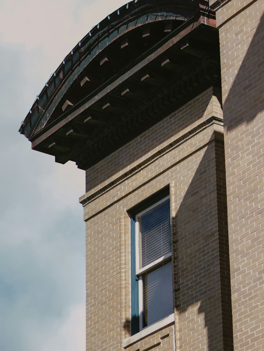 a brick building with a round window