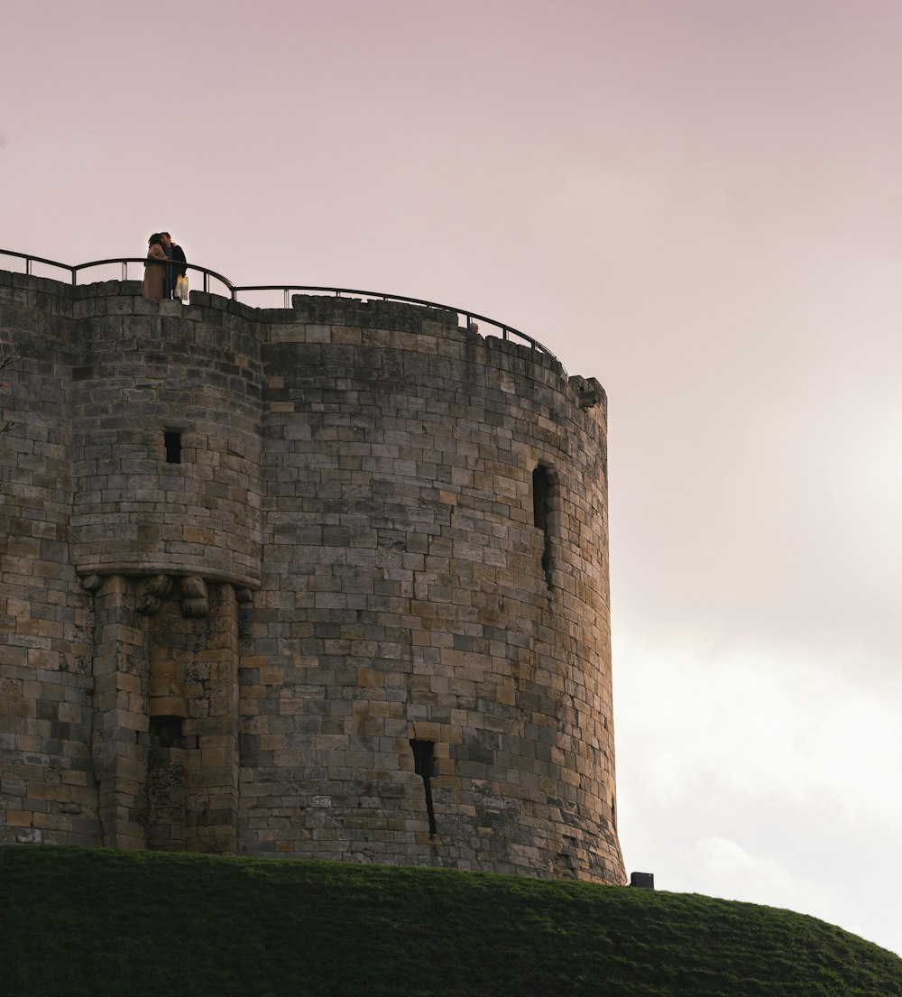 a person standing on a stone tower