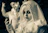 A close-up of a mysterious figure in gothic attire with intricate lace and dark makeup.