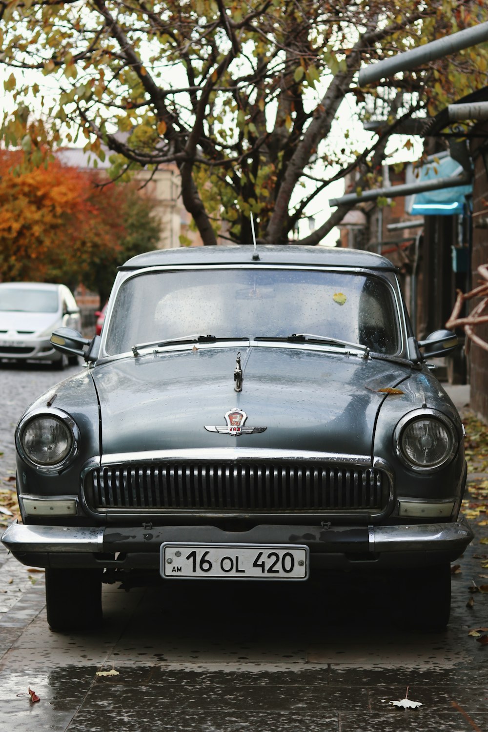 a black car parked on the side of a street