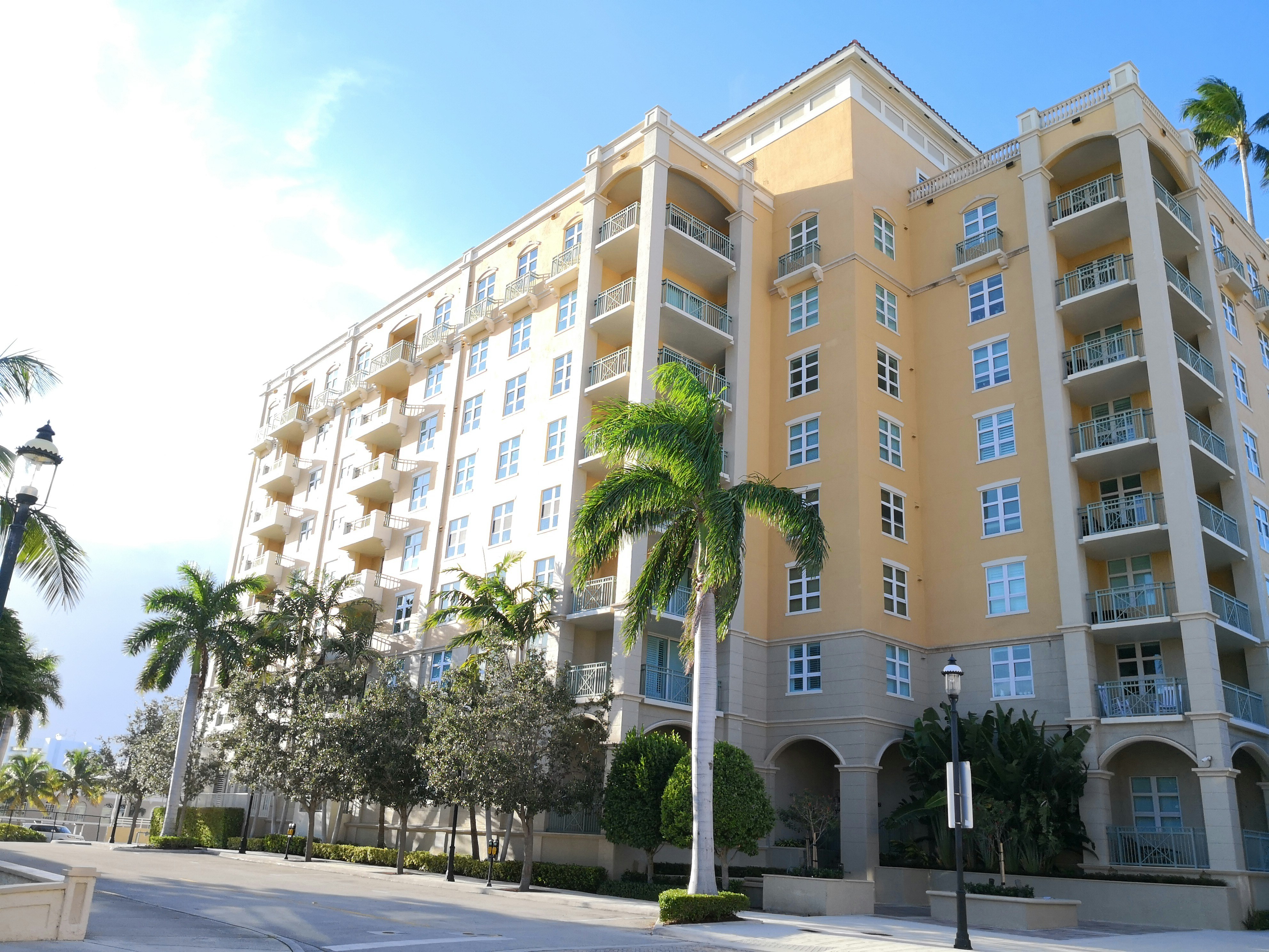 a building with palm trees in front
