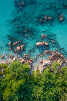 a body of water with rocks and trees around it