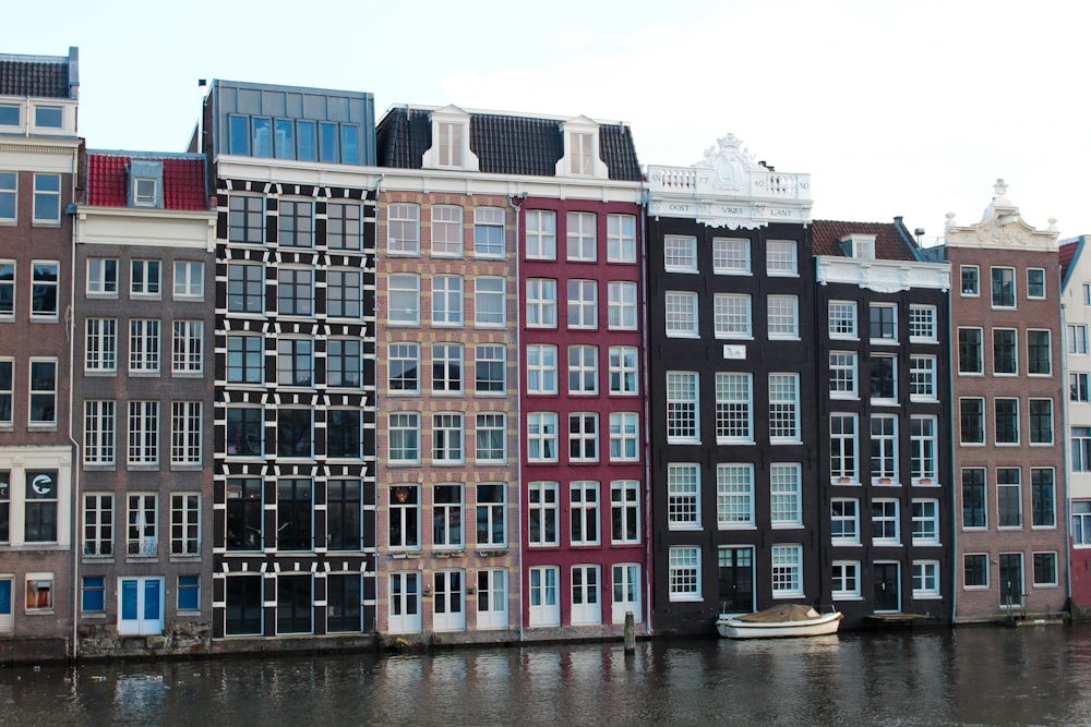 a row of buildings next to a body of water