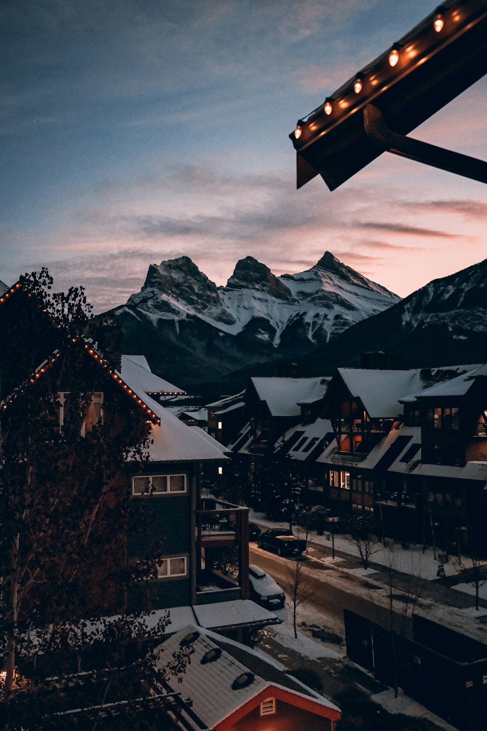 a snowy town with mountains in the background