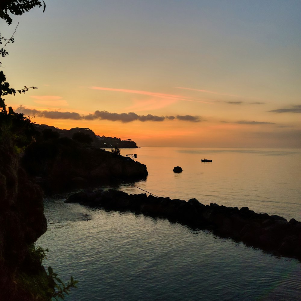 a body of water with a beach and trees around it