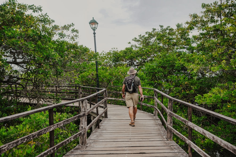 a person walking on a wooden bridge