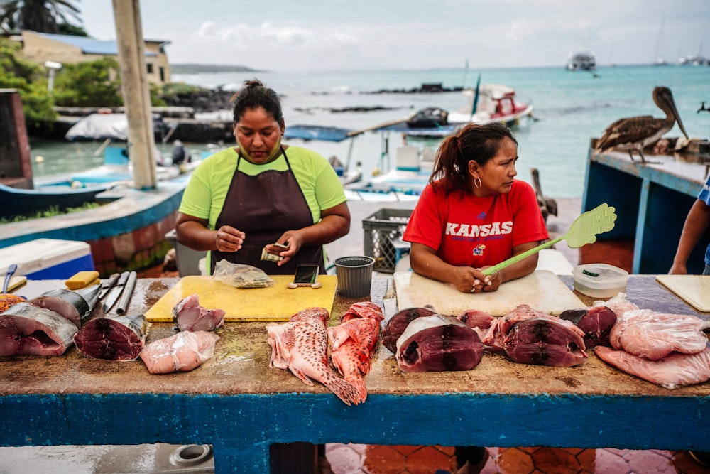 a man and a woman cutting meat