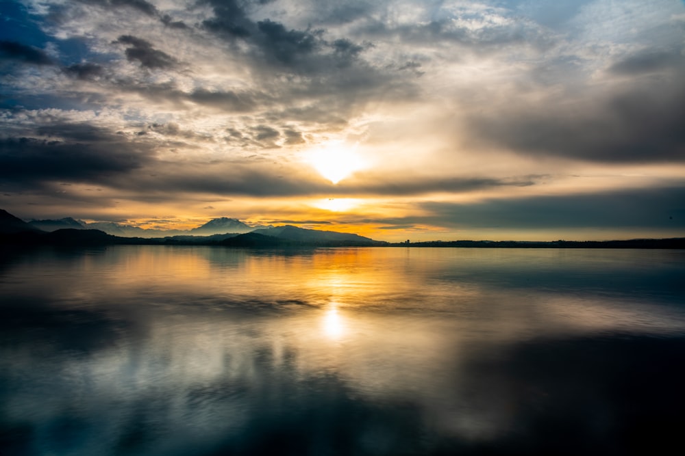 a body of water with a sunset