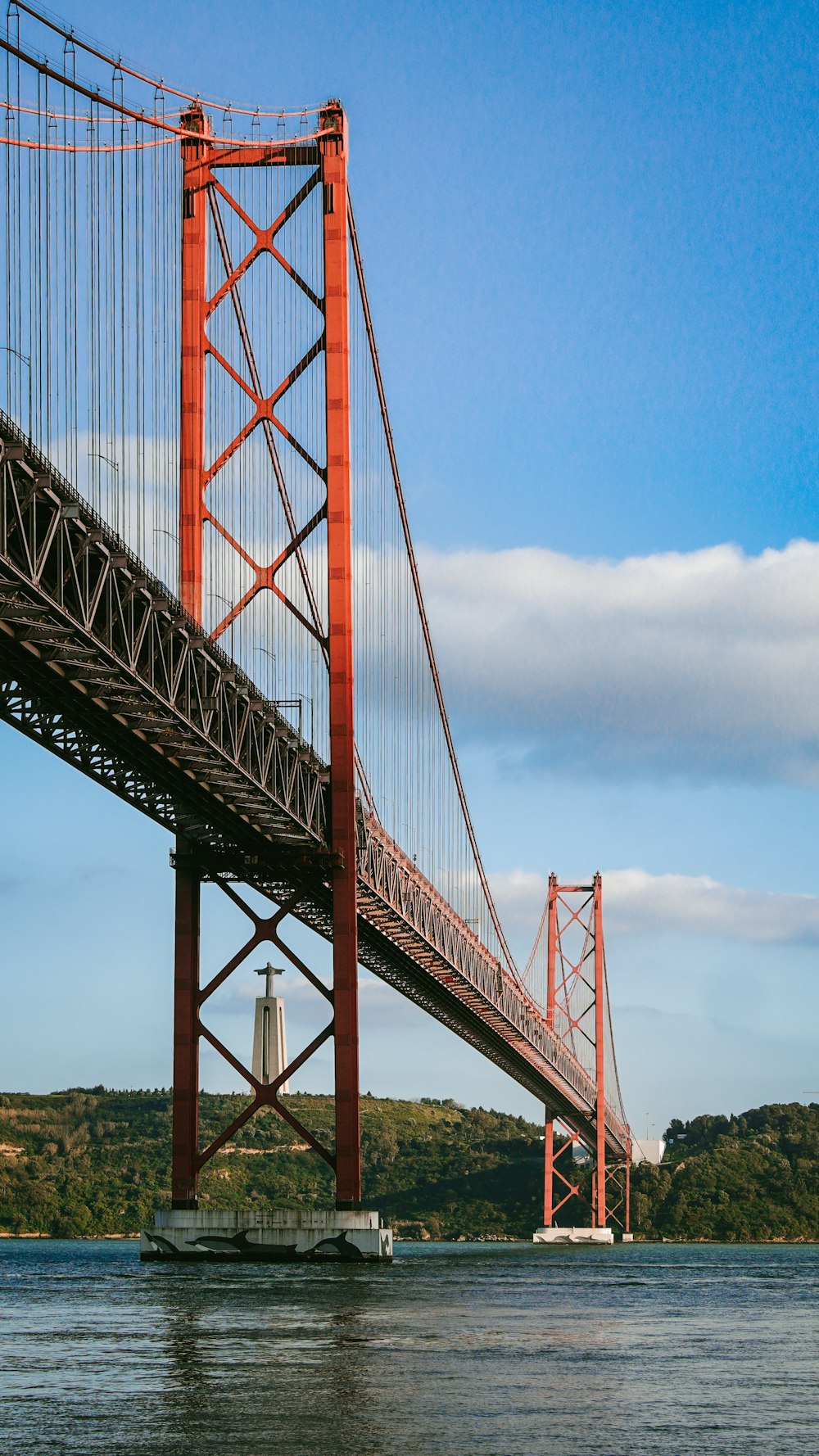 a large red bridge over water