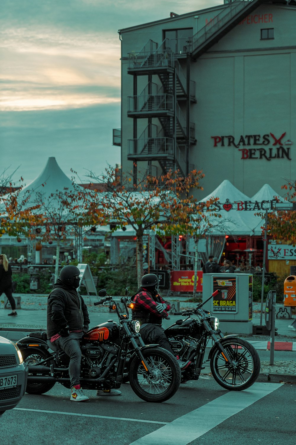 a group of people stand on motorcycles