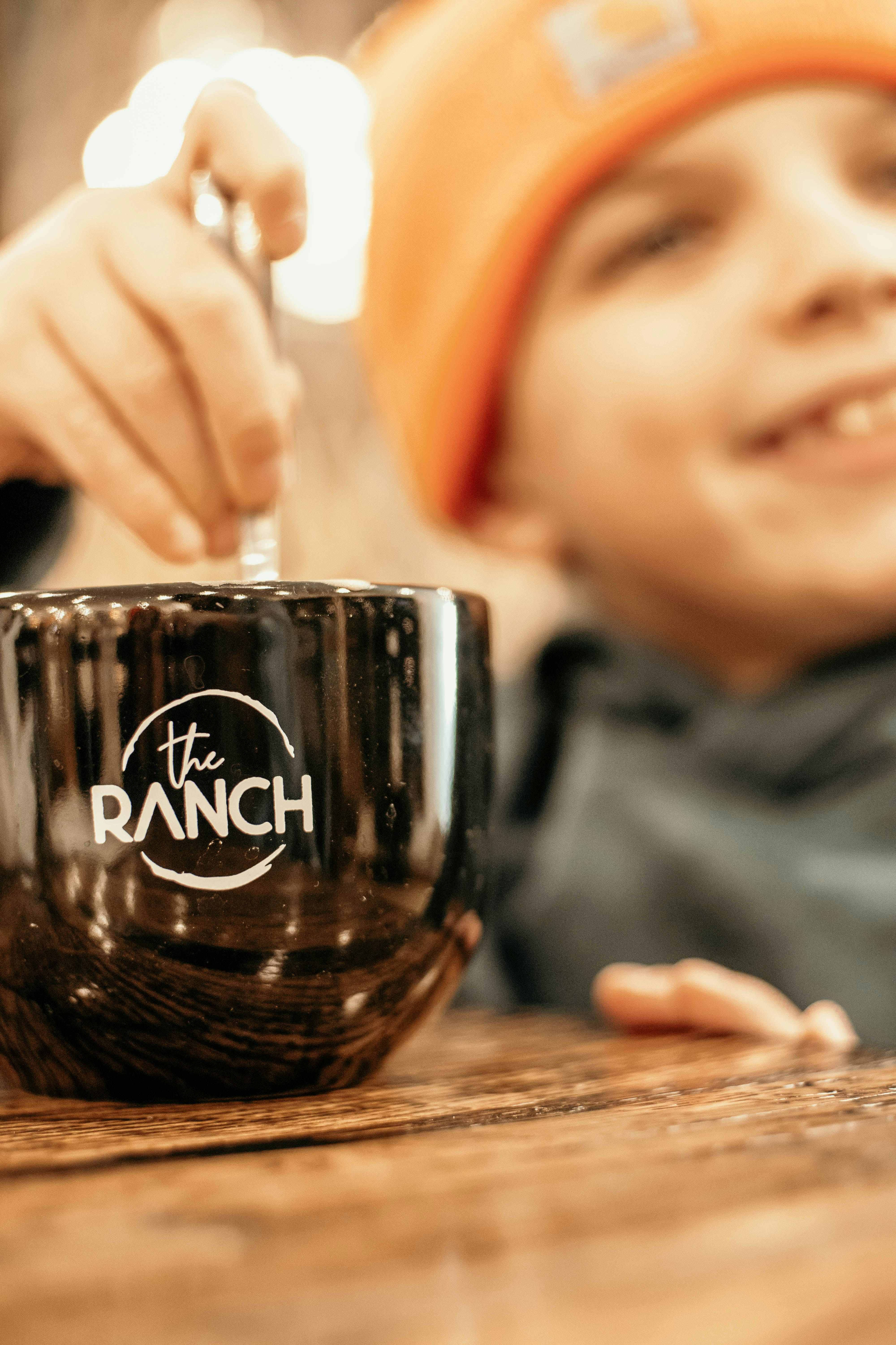 a person pouring a drink into a glass